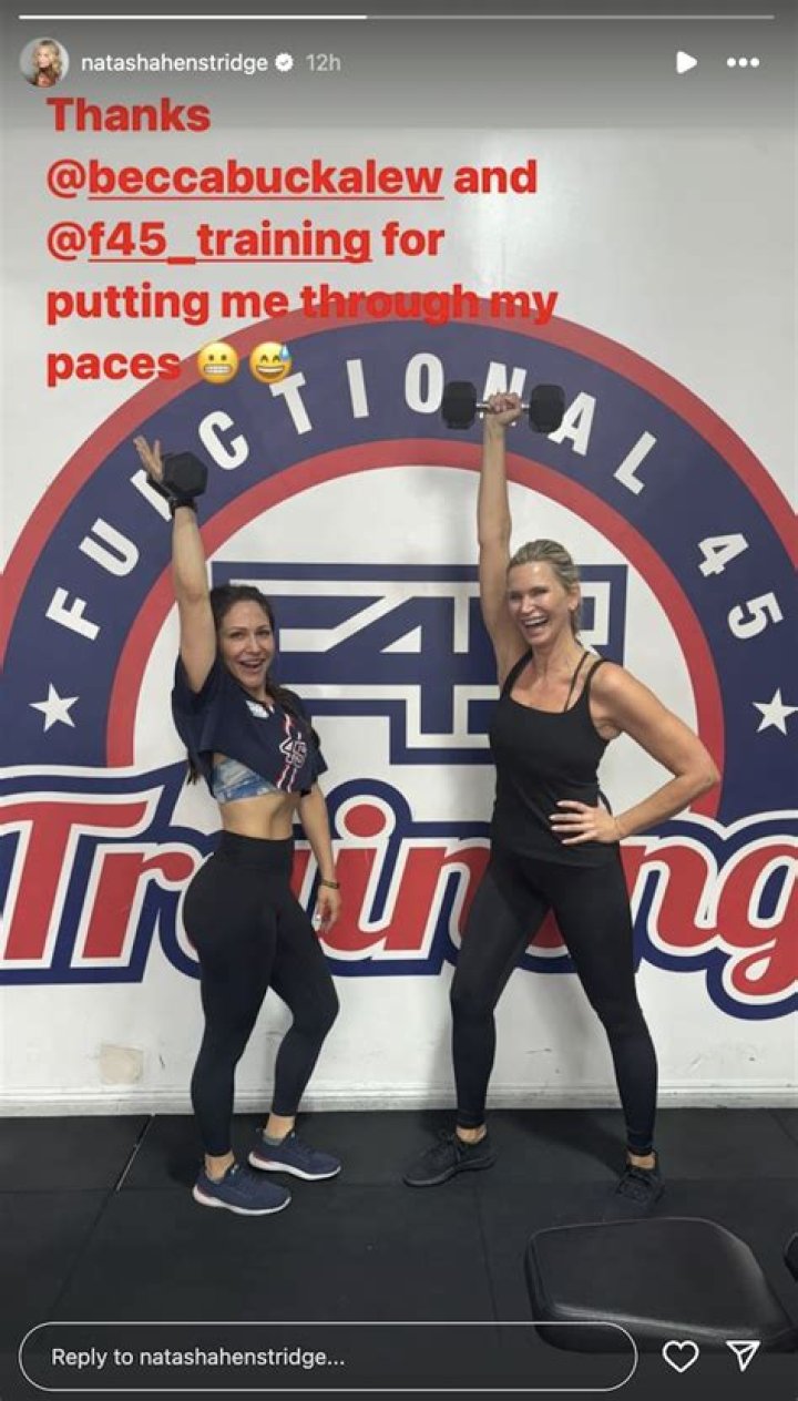 Natasha Henstridge in Black Workout Gear Poses With Her Trainer